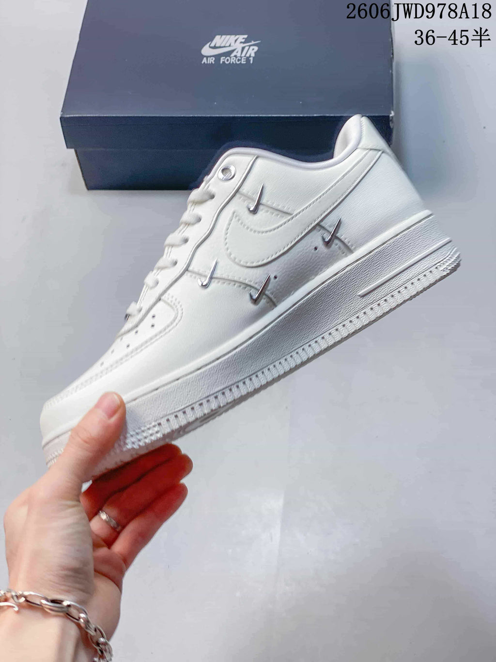 Nike Air Force 1 Low White Sneakers with Metallic Swoosh Details