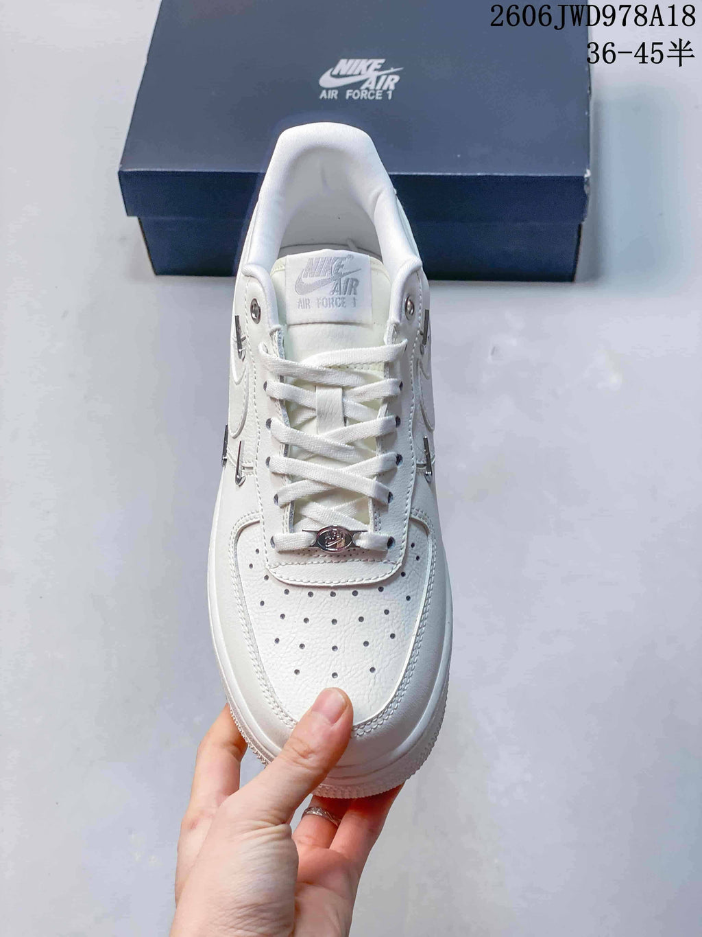 Nike Air Force 1 Low White Sneakers with Metallic Swoosh Details